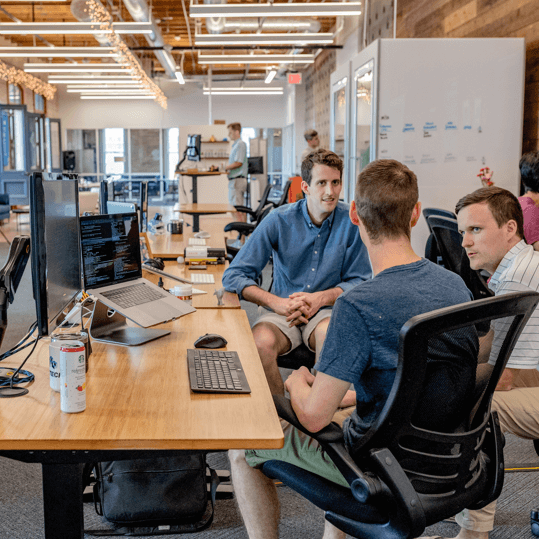 The RDU Digital team working together in the office